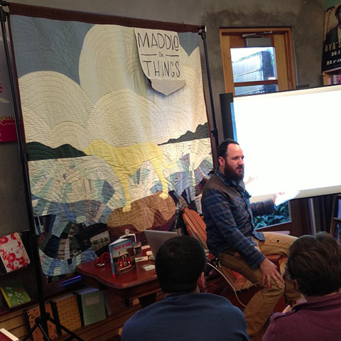 Molly Evans | Art Quilts Theron sitting in front of quilt