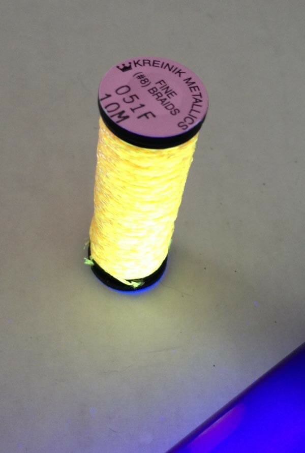 Using Threads For Special Effects Set up a black light or ultraviolet light for a longer glow life.