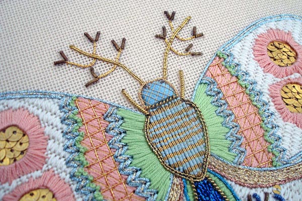 Meet Our Sponsor! Kreinik Threads! This needlepoint butterfly is a highly stylistic depiction, a blend of stitches and thread types.