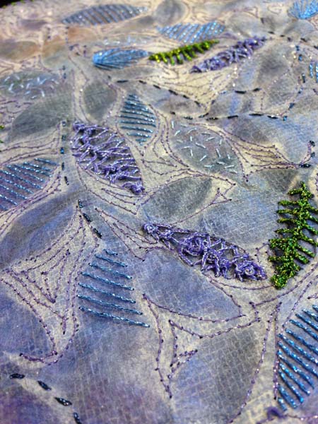 Bring On The Light Sam used a variety of stitches in a combination of hand and machine embroidery using metallic threads on silk paper. Kreinik Fashion Twist is used for the machine stitching, while various sizes (thicknesses) of Kreinik Braids are used for the hand embroidery.