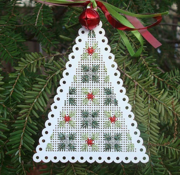 A Few Of My Favorite Free Christmas Projects Metallic and reflective thread in sparkling straight stitches on a perforated paper tree shape.
