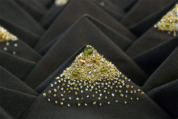 Detail of the embroidery embellishment on select points of the folds.